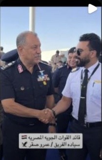 Snapchat tile showing the subject shaking hands with a uniformed officer, with an Arabic caption identifying Air Force commander Amr Saqr